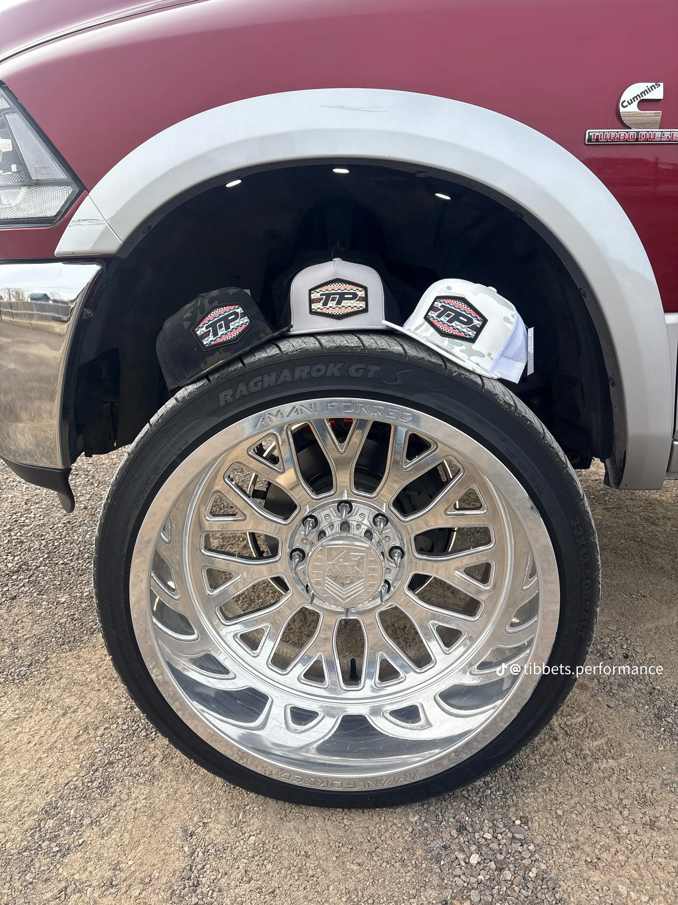 Tibbets Performance hats displayed on a chrome wheel