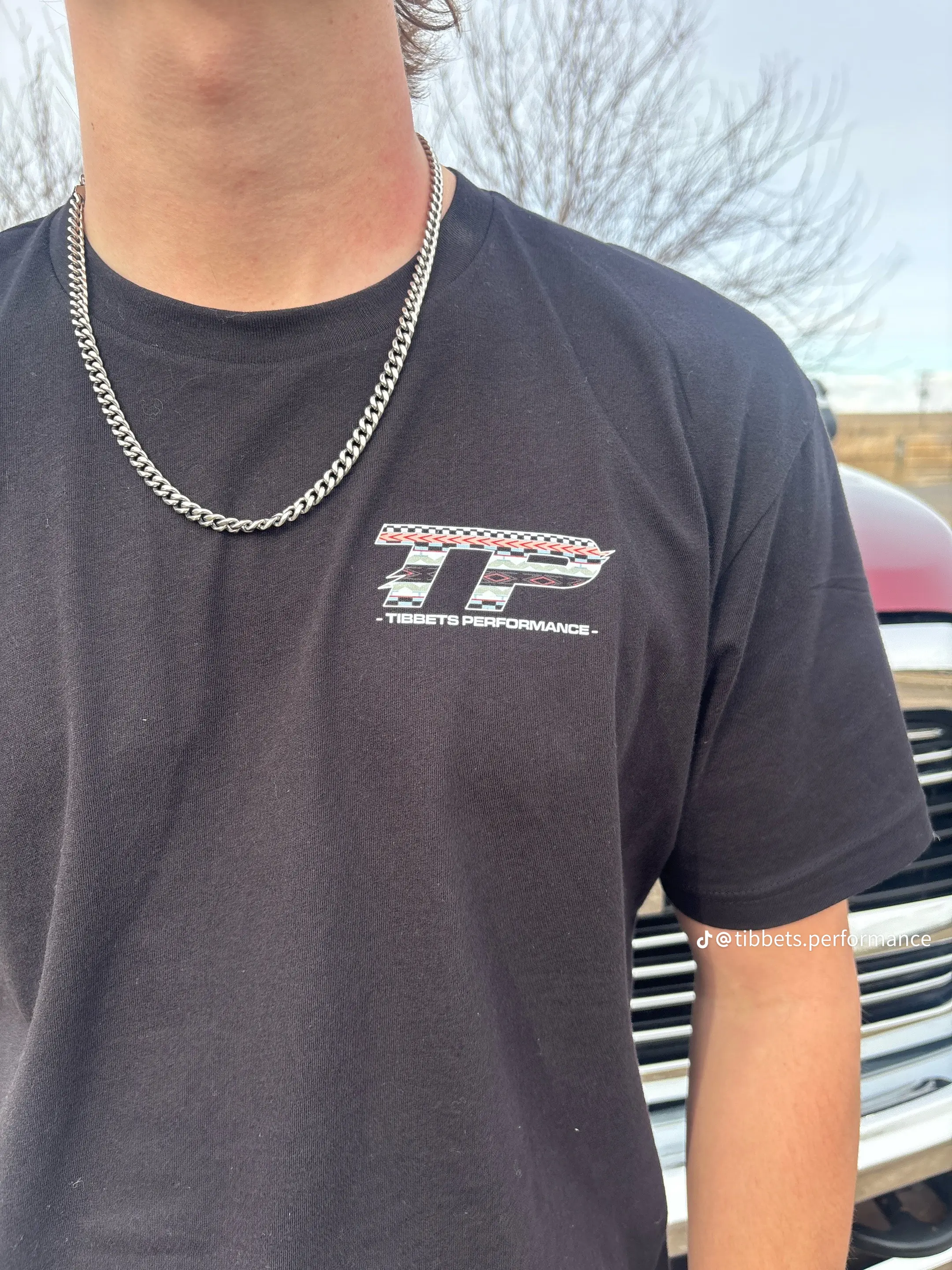 Front logo detail on the Tibbets Performance shirt